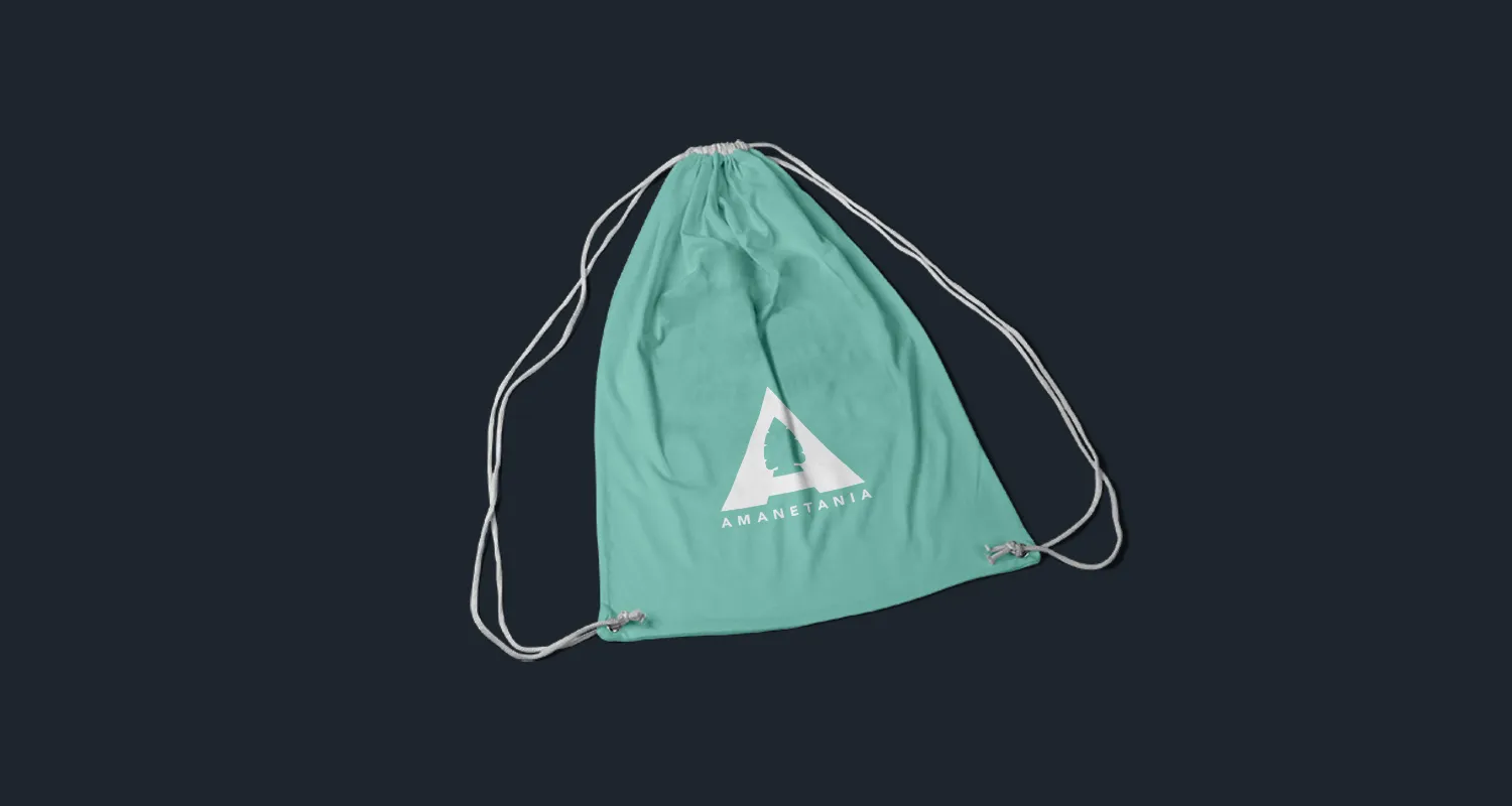 A green drawstring bag carrying the Amanetania mark in white