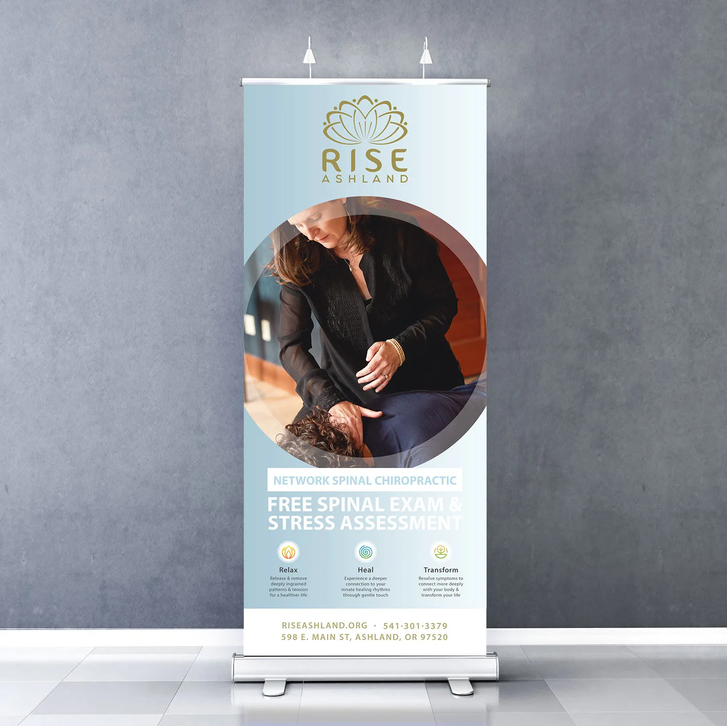 A roll-up display banner offering a free spinal exam and stress assessment, used at meetings and events